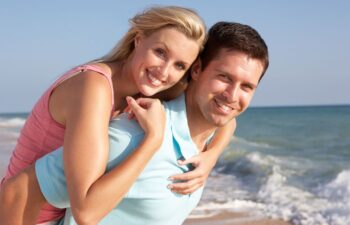 happy middle-aged couple spending time on a beach on a sunny day